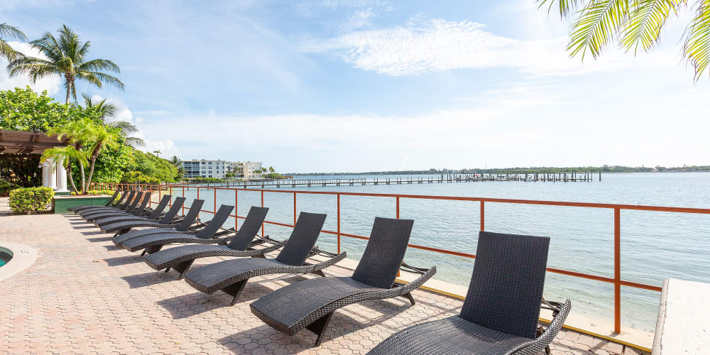 Waterfront seats by the pool at Manatee Bay Apartments in Boynton Beach, Florida