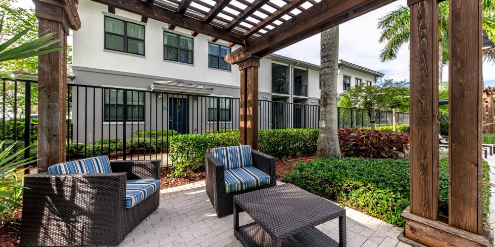 Outdoor seating at The Hamptons at Palm Beach Gardens Apartments in Palm Beach Gardens, Florida