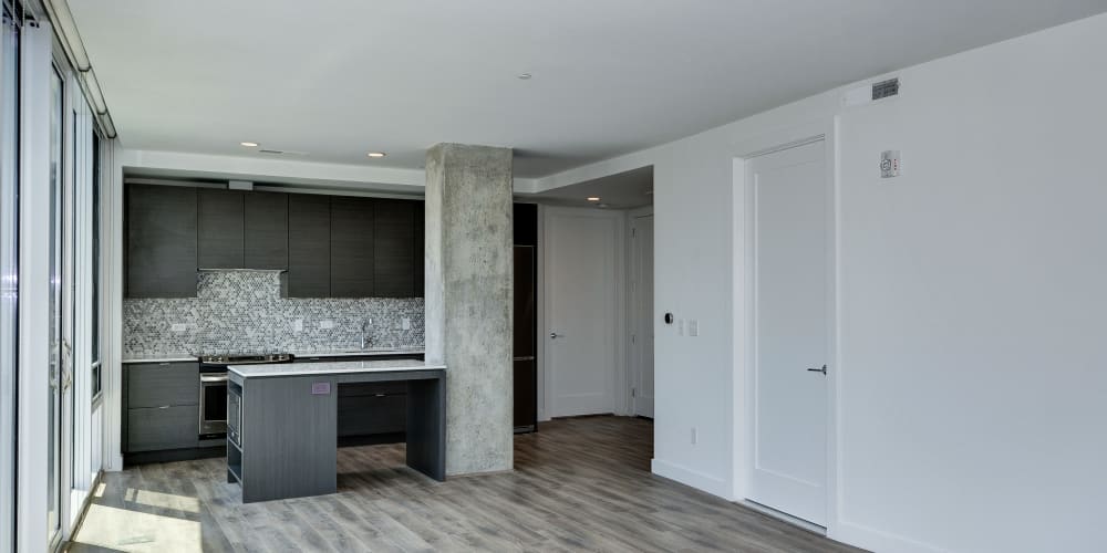 Open concept living area that has light wood style flooring all throughout at The Corcoran in Washington, District of Columbia