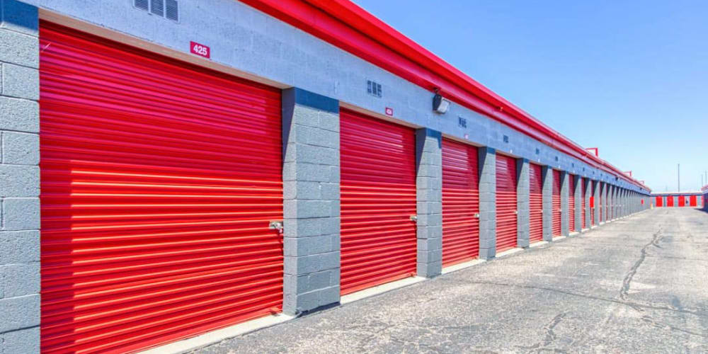 Row of outside storage units with bright red doors at Devon Self Storage in Phoenix, Arizona
