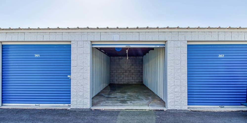 Outdoor storage units with bright blue doors at Devon Self Storage in Mesa, Arizona