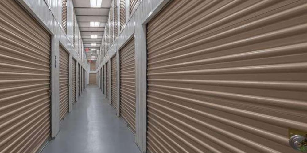 Clean and well-lit indoor storage hallways at Devon Self Storage in Pompano Beach, Florida