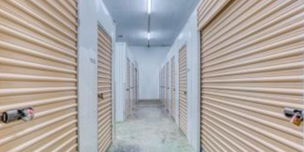 Clean and well-lit indoor storage unit hallway at Devon Self Storage in Gulfport, Florida