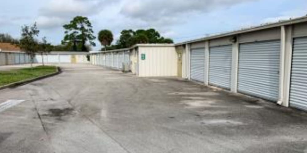 Secure bright white doors on outdoor storage units at Devon Self Storage in Port St. Lucie, Florida
