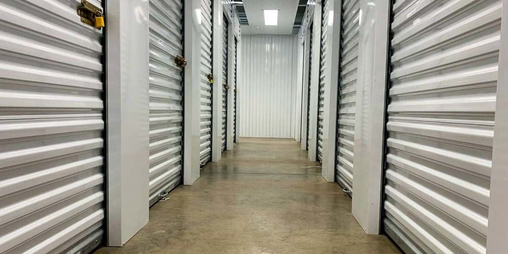 Clean and very well-lit indoor storage hallway at Devon Self Storage in Lynwood, Illinois