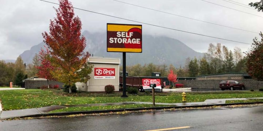 Large sign welcoming new and existing tenants to Devon Self Storage in North Bend, Washington