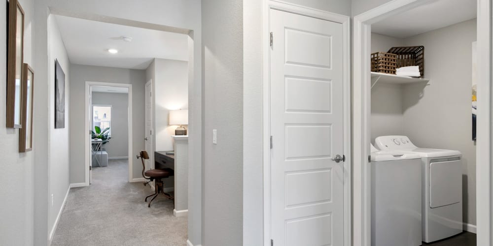 Large hallway with a washer and dryer at the end for easy laundry day at BB Living at Light Farms in Celina, Texas