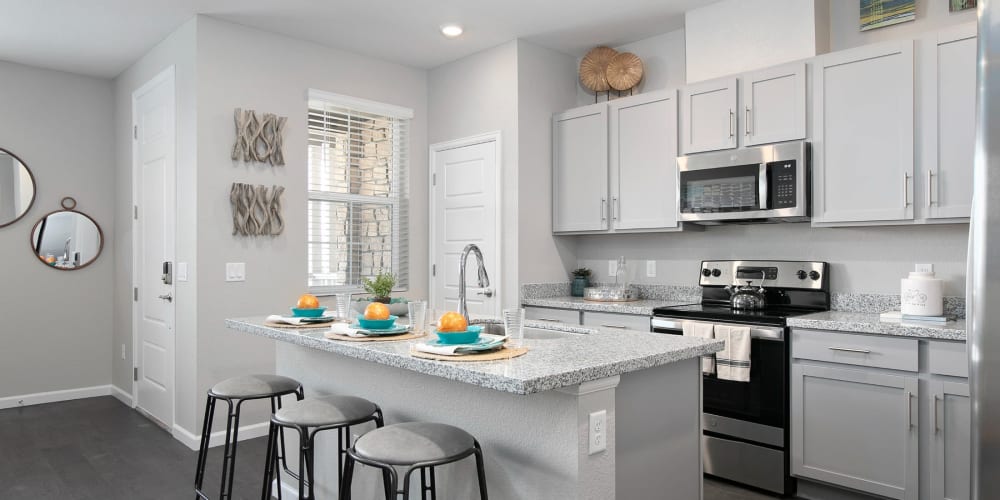 Sleek white cabinets and stainless steel appliances in the kitchen at BB Living at Light Farms in Celina, Texas