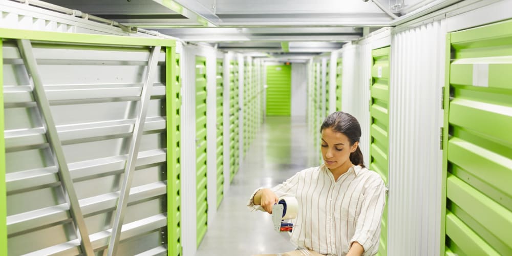 a customer packing into an indoor unit at Trojan Storage of Lynnwood in Lynnwood, Washington