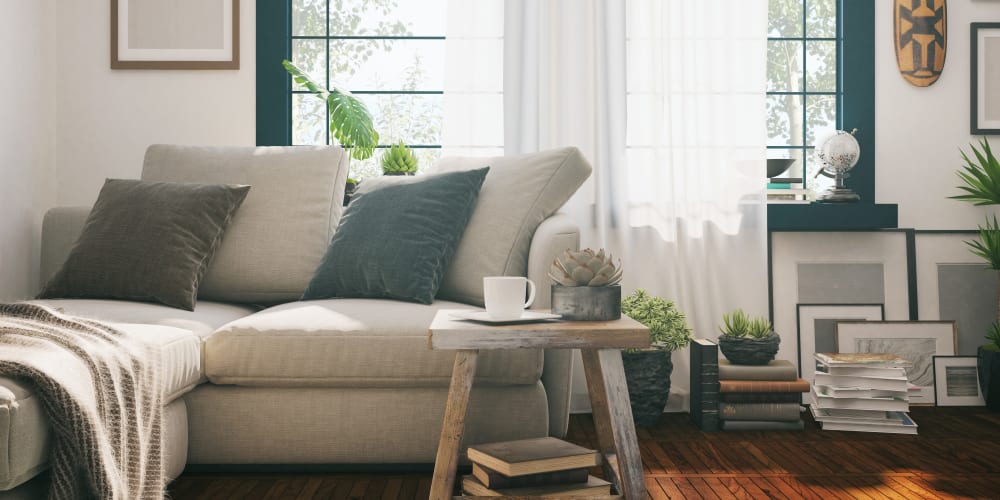 Draped bay windows and modern furnishings in a model home's living area at Farmstead at Lia Lane in Santa Rosa, California