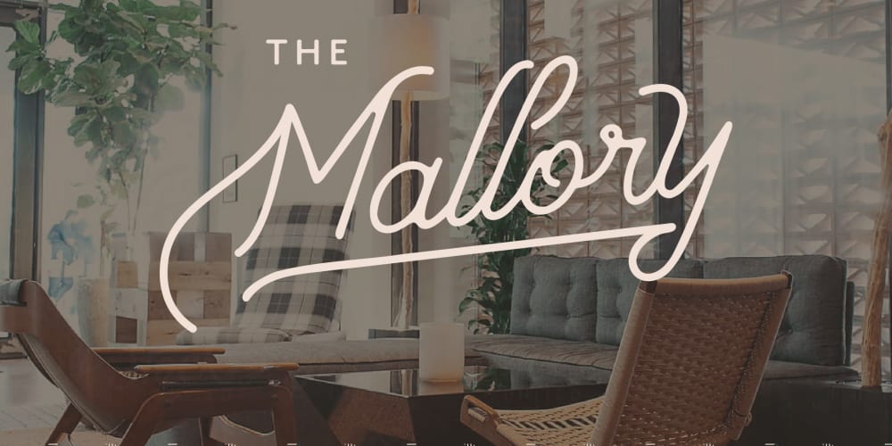 Logo with a nice apartment in the background at The Mallory in Raleigh, North Carolina