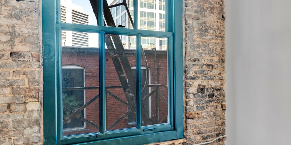 A bright loft apartment bedroom window at Theatre Lofts in Birmingham, Alabama