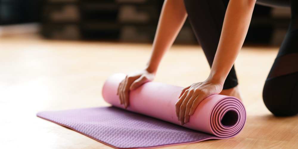 Resident rolling a yoga mat at Mosby Bridge Street in Huntsville, Alabama