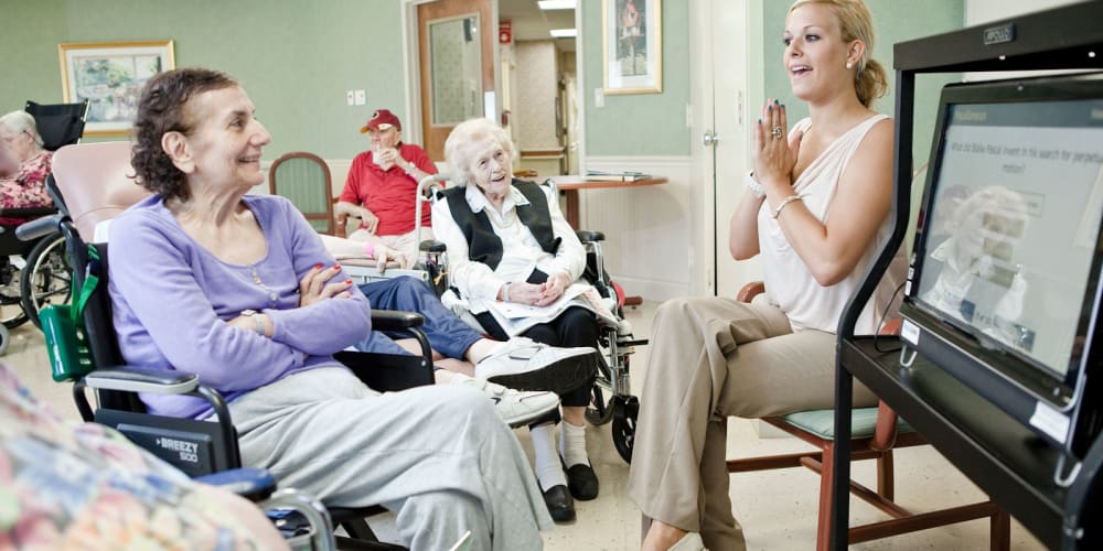 Staff talking with residents about video games at Vista Prairie at Fieldcrest in Sheldon, Iowa