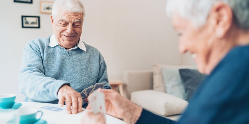 Independent senior couple playing cards at Vista Prairie at Monarch Meadows in North Mankato, Minnesota