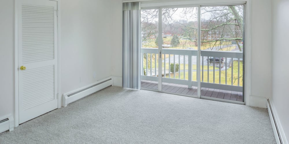 Master Bedroom with a balcony overlooking the community at The Four Seasons Apartments in East Providence, Rhode Island