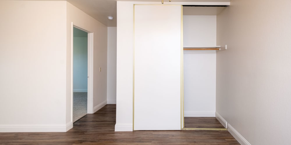 Large closets in an apartment home with wood-style flooring at Peppertree Apartments in San Jose, California