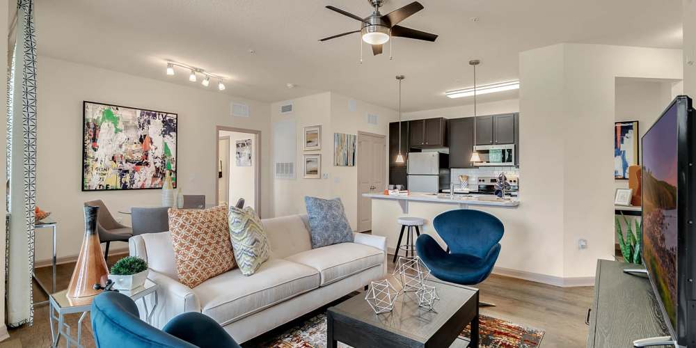 Furnished apartment living room with ceiling fan at Art Avenue Apartment Homes in Orlando, Florida