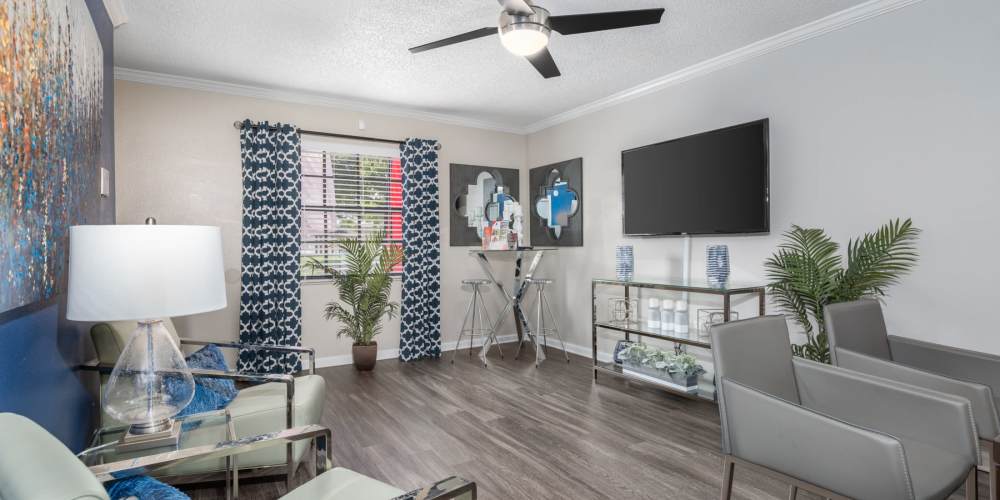 Spacious furnished living room with hardwood flooring at Barrington Place at Winter Haven in Winter Haven, Florida
