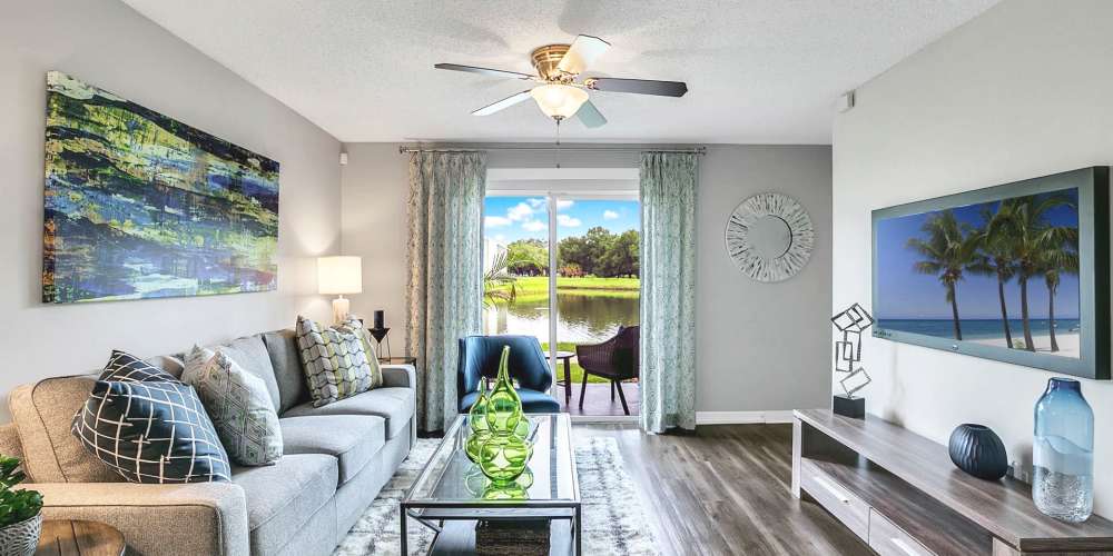 Furnished living room with hardwood floors and private patio access at Lakeside Central Apartments in Brandon, Florida