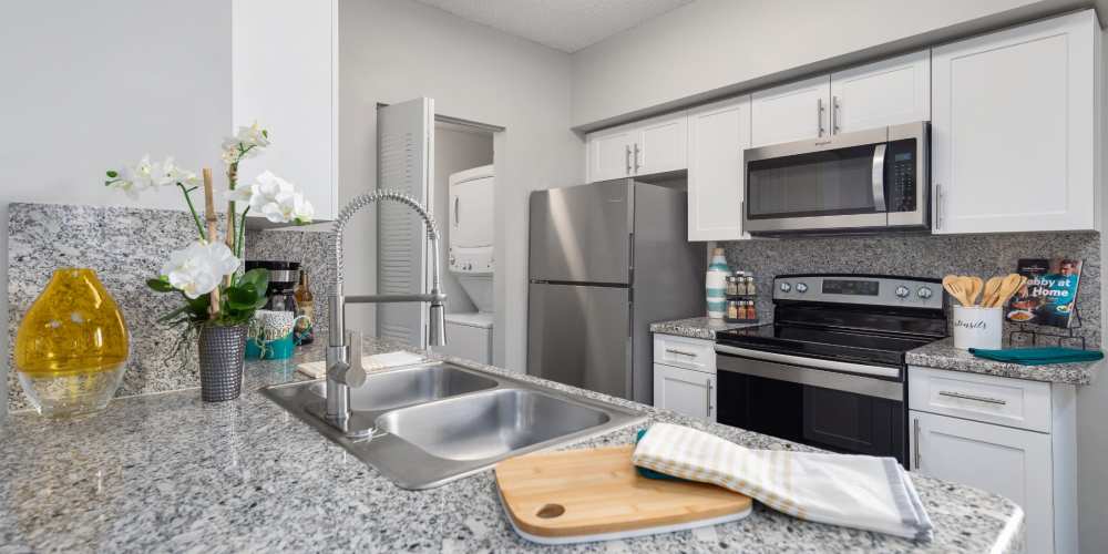 Modern apartment kitchen with stainless steel appliances at Nova Central Apartments in Davie, Florida