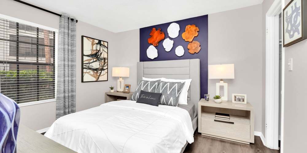 Apartment bedroom with queen-size bed and matching bedside tables at 4800 Westshore in Tampa, Florida
