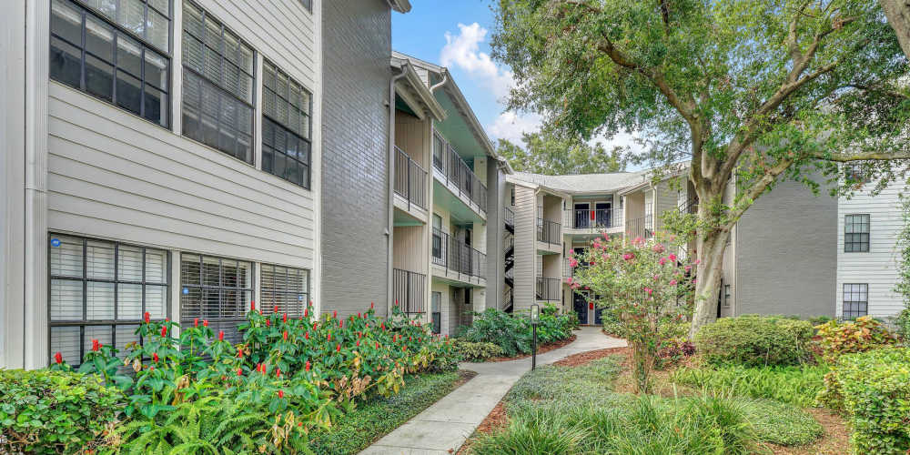 Exterior of apartment complex with walkways and gardens at 4800 Westshore in Tampa, Florida
