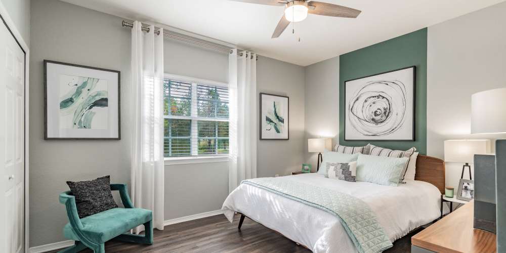 Furnished apartment bedroom with ceiling fan and full size bed at The Parq at Cross Creek in Tampa, Florida