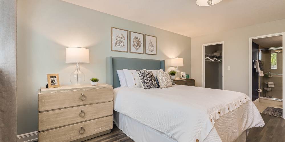Apartment bedroom with matching end tables at Waters Pointe in South Pasadena, Florida