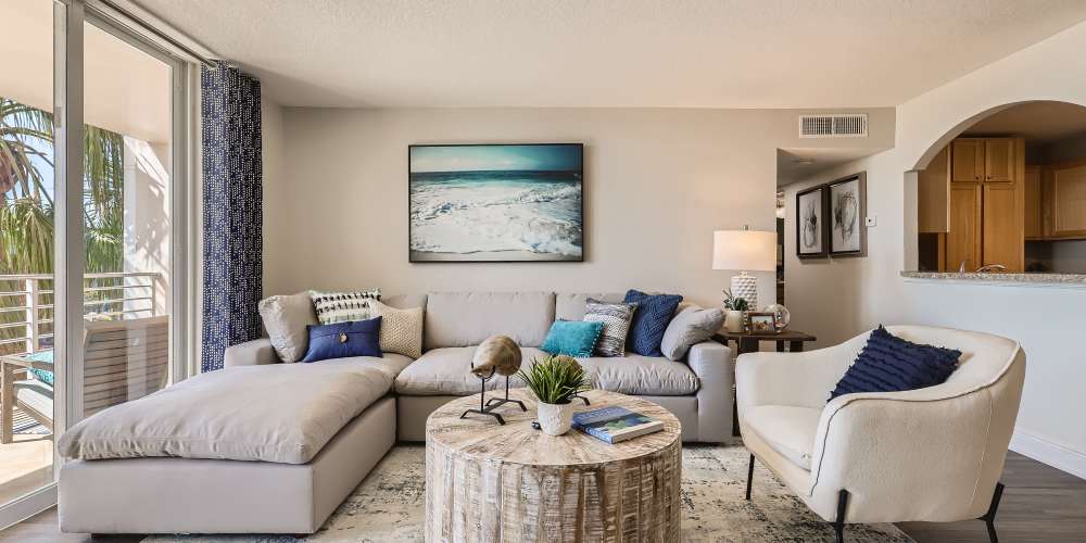 Apartment living room with sectional sofa at Waters Pointe in South Pasadena, Floridag