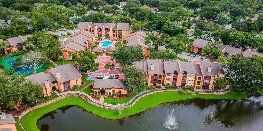 Aerial view of apartment complex with large pond at Waterstone At Carrollwood in Tampa, Florida