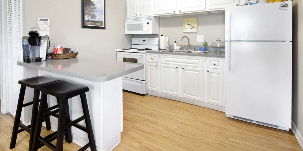 Apartment kitchen with major appliances at Windward Apartments in Orlando, Florida