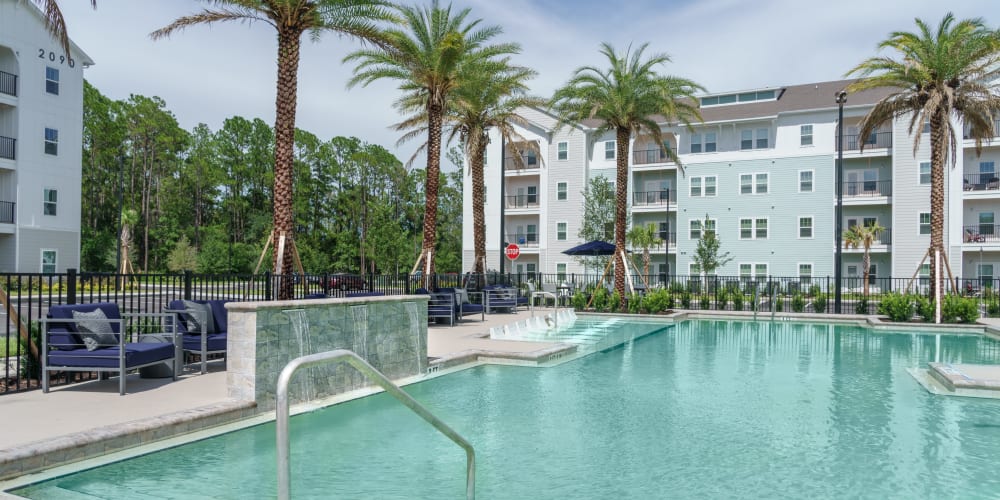 The swimming pool with apartments in the background at The Station at Fleming Island in Fleming Island, Florida