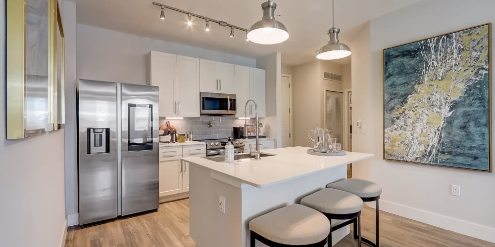 An apartment kitchen with an island at Mallory Square at Lake Nona in Orlando, Florida