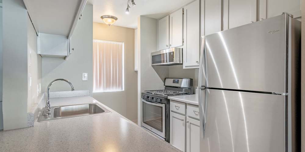 An apartment kitchen with stainless-steel appliances at Sunset Ridge Apartments in Lancaster, California