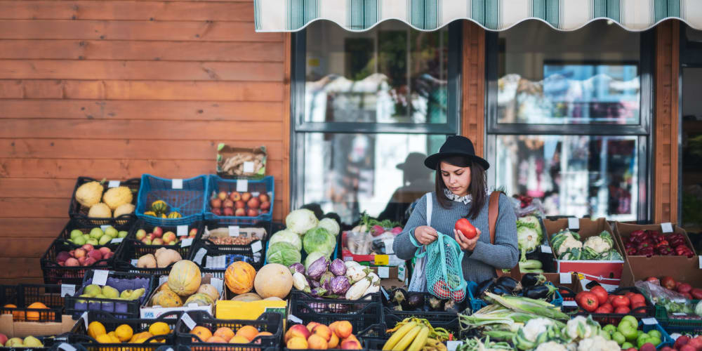 Resident shopping for produce at a market near K Street Flats in Berkeley, California