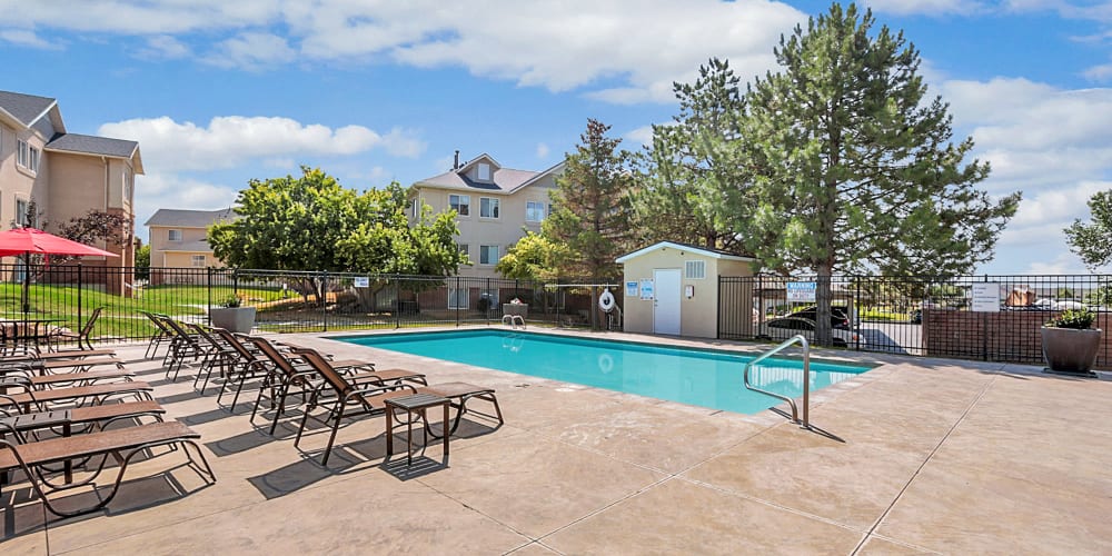 Deck chair around outdoor swimming pool at Mayflower Harbor at Pilgrims Landing in Lehi, Utah