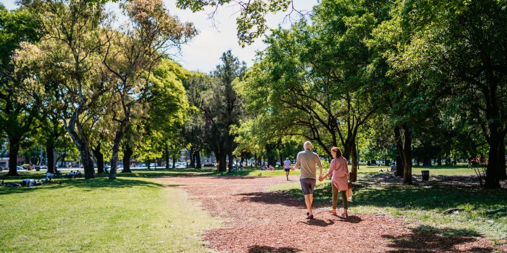 Couple walking in a park near Hub Apartments in Folsom, California