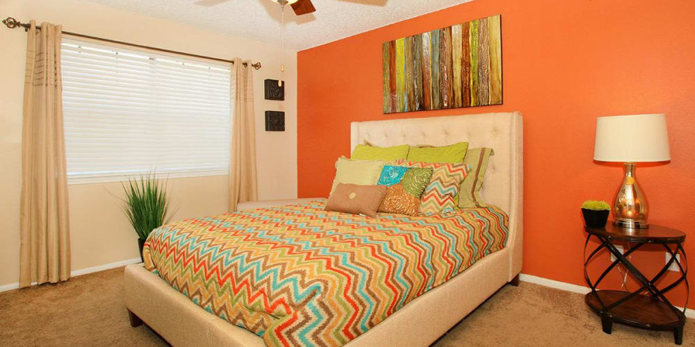 A furnished apartment bedroom at The Granite at Tuscany Hills in San Antonio, Texas