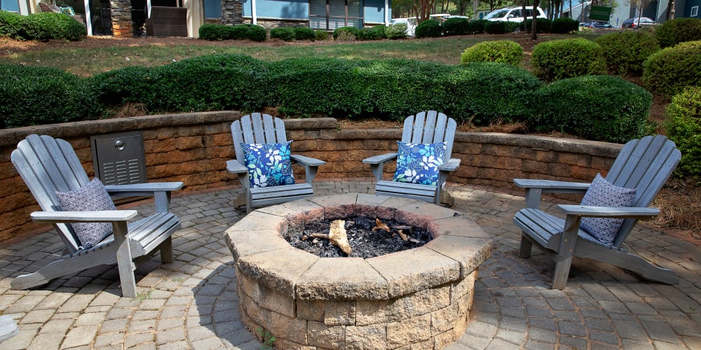 Outdoor chairs around a firepit at Dwell at Carmel in Charlotte, North Carolina