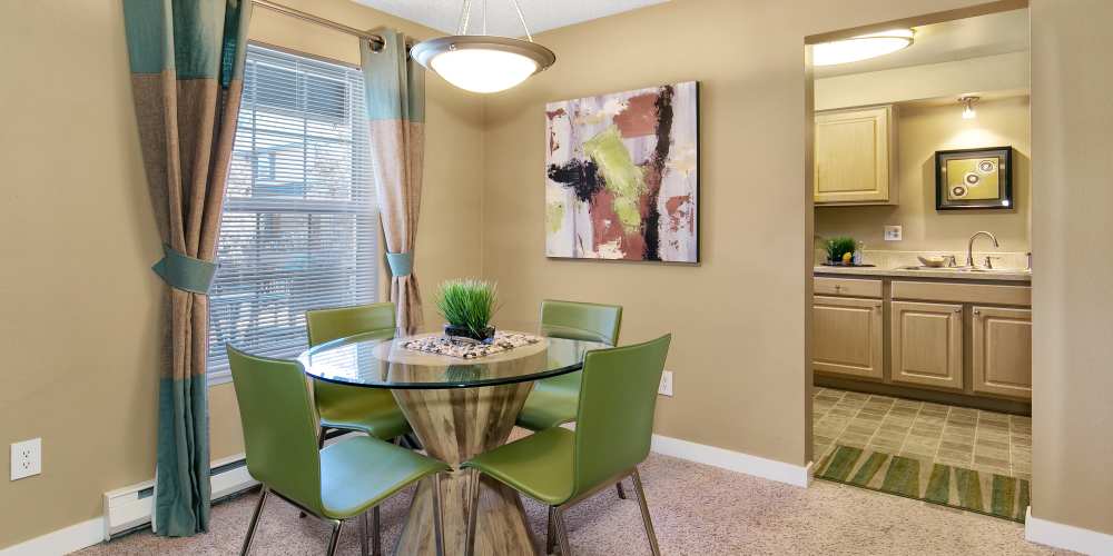 Apartment dining room with a large window at Collins Junction in Lynnwood, Washington