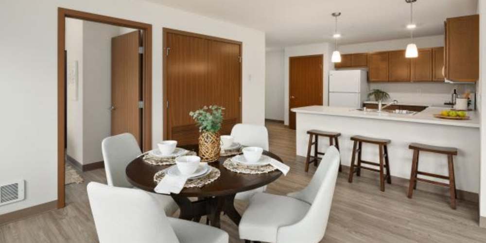 Dining room table set for four at Four Pines Apartments in Burlington, Washington