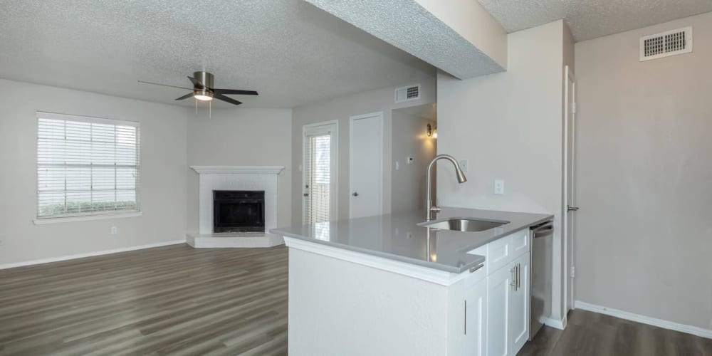 Spacious kitchen and living room with fireplace at Tides on Randol West in Fort Worth, Texas