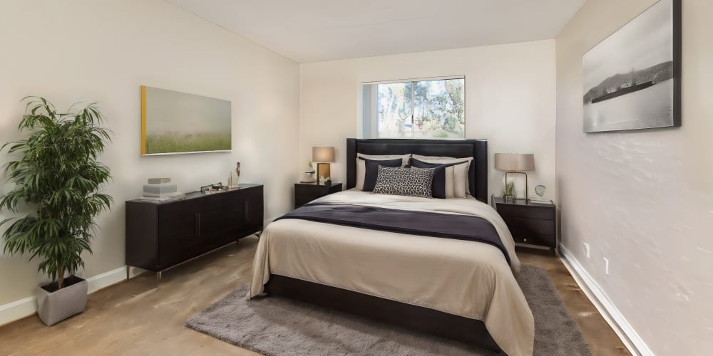 Apartment bedroom with matching dark wooden end tables at Martinez Hillside in Martinez, California