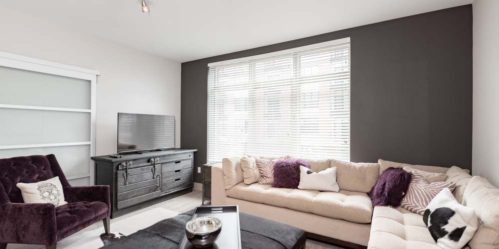 A sectional couch, arm chair and entertainment center in an apartment at Crocker Park Living in Westlake, Ohio