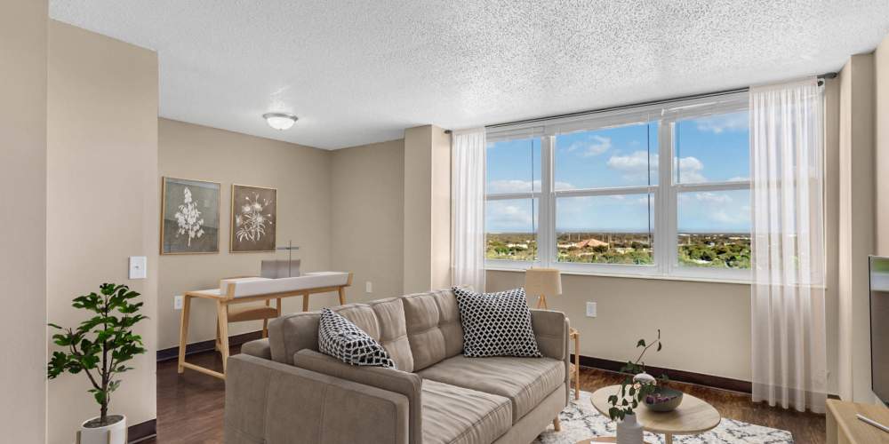 Spacious apartment living room with hardwood floors and scenic views at Bay Pointe Tower in South Pasadena, Florida