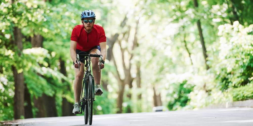 Resident biking near Evergreen Park Townhomes and Apartments in Lansing, Michigan