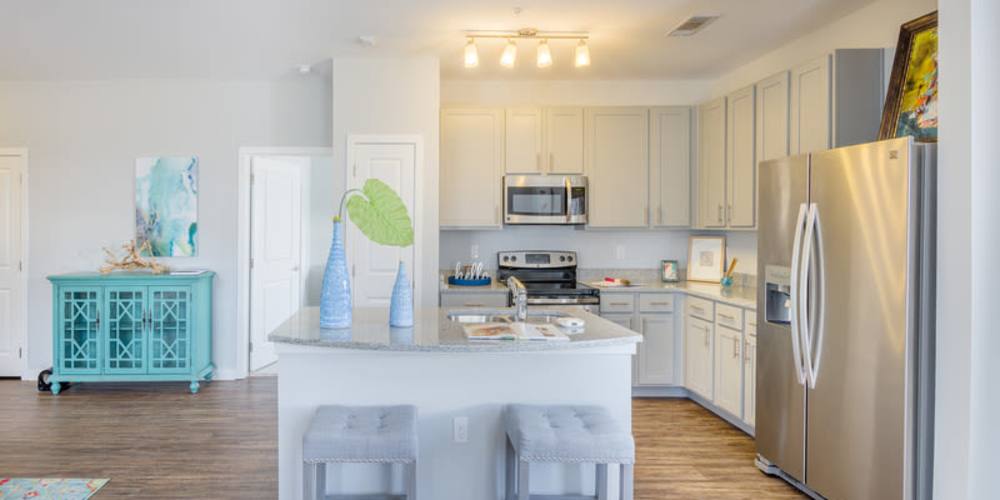 An upgraded kitchen with an island at Reserve at River Place in Youngsville, Louisiana