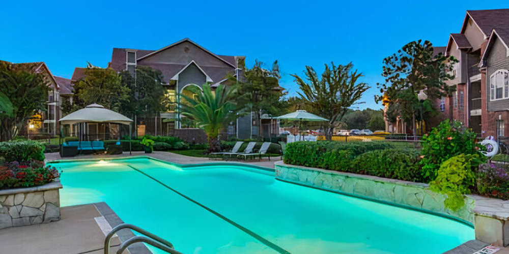 Swimming pool and grounds at dusk at Augusta North in Houston, Texas