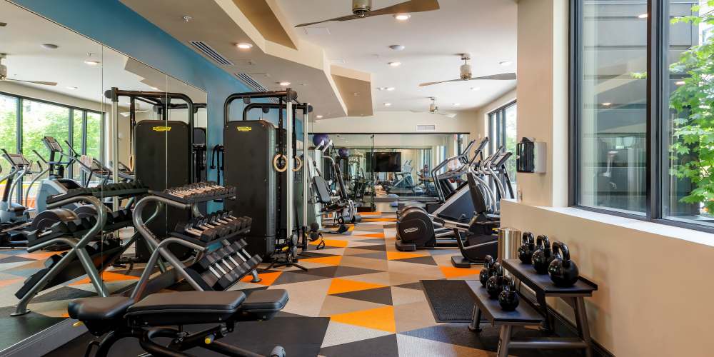 Fitness center with plenty of weight machines at Sandy Lofts in Portland, Oregon